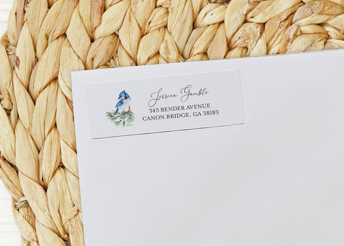 White envelope with personalized address on a woven mat