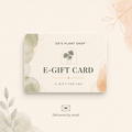 A decorative e-gift card from Ed's Plant Shop with a minimalist design, featuring watercolor botanical accents in soft green and peach on a cream card, shown on a matching light beige background with a small email delivery icon below.