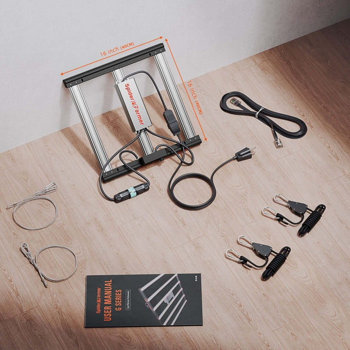 Grow light components and accessories on a wooden surface with a white wall background.